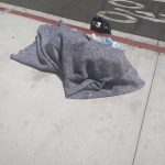 man in blanket, on ground