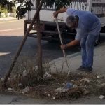 man sweeping trash